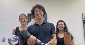 Tripi and fellow students holding the prosthetics they made